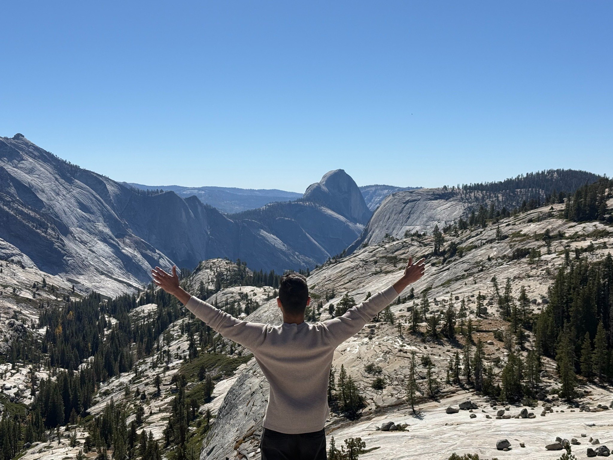 Looking toward Half Dome in Yosemite with arms outstretched
